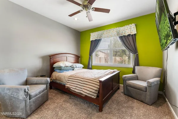 a bedroom with a bed a couch and a window