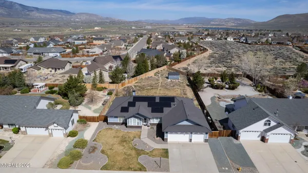 an aerial view of residential houses with outdoor space