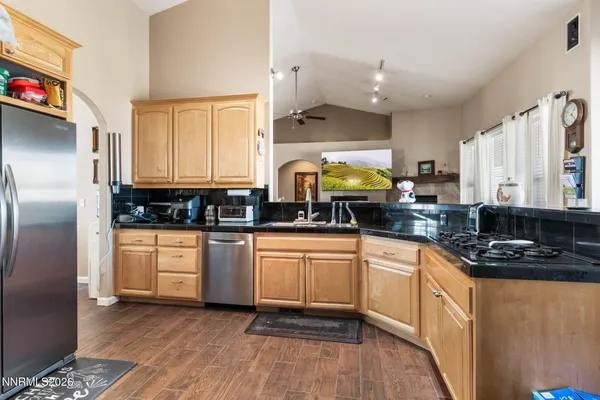 a kitchen with stainless steel appliances a refrigerator sink stove microwave and cabinets