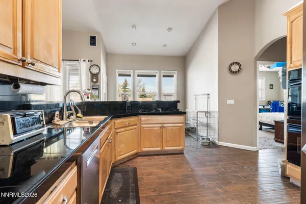 a kitchen with granite countertop a stove and cabinets