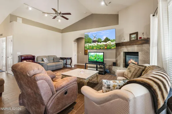 a living room with furniture fireplace and a large window