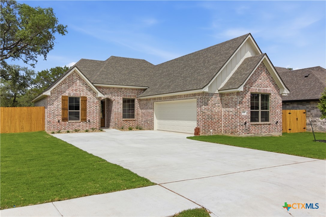 1206 Rylee Lane Salado, TX 76571 - Photo 2 of 3 a front view of a house with a garden and yard