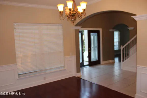 a view of a hallway with entryway wooden floor and front door