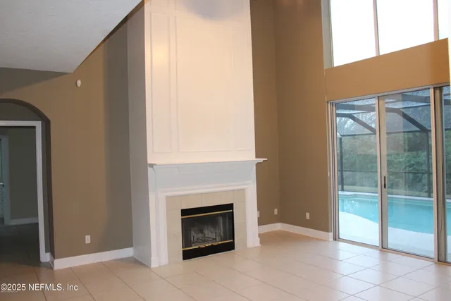 a view of an empty room and fire place