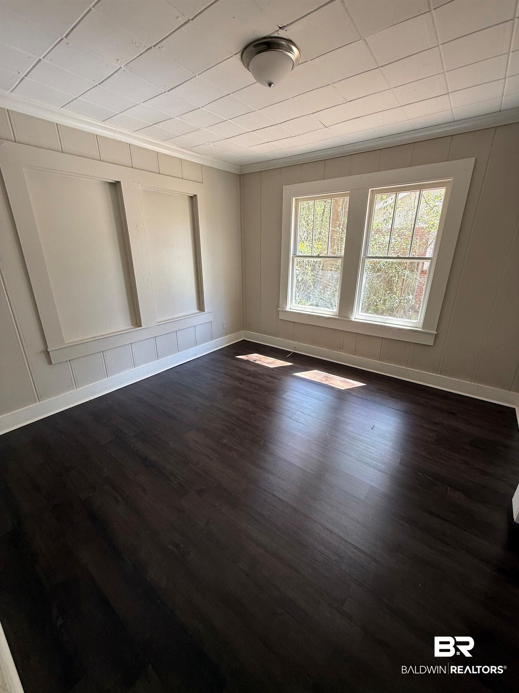 655 Mandrell Street Mobile, AL 36606 - Photo 8 of 12 Unfurnished room featuring a decorative wall, dark wood-style floors, and ornamental molding