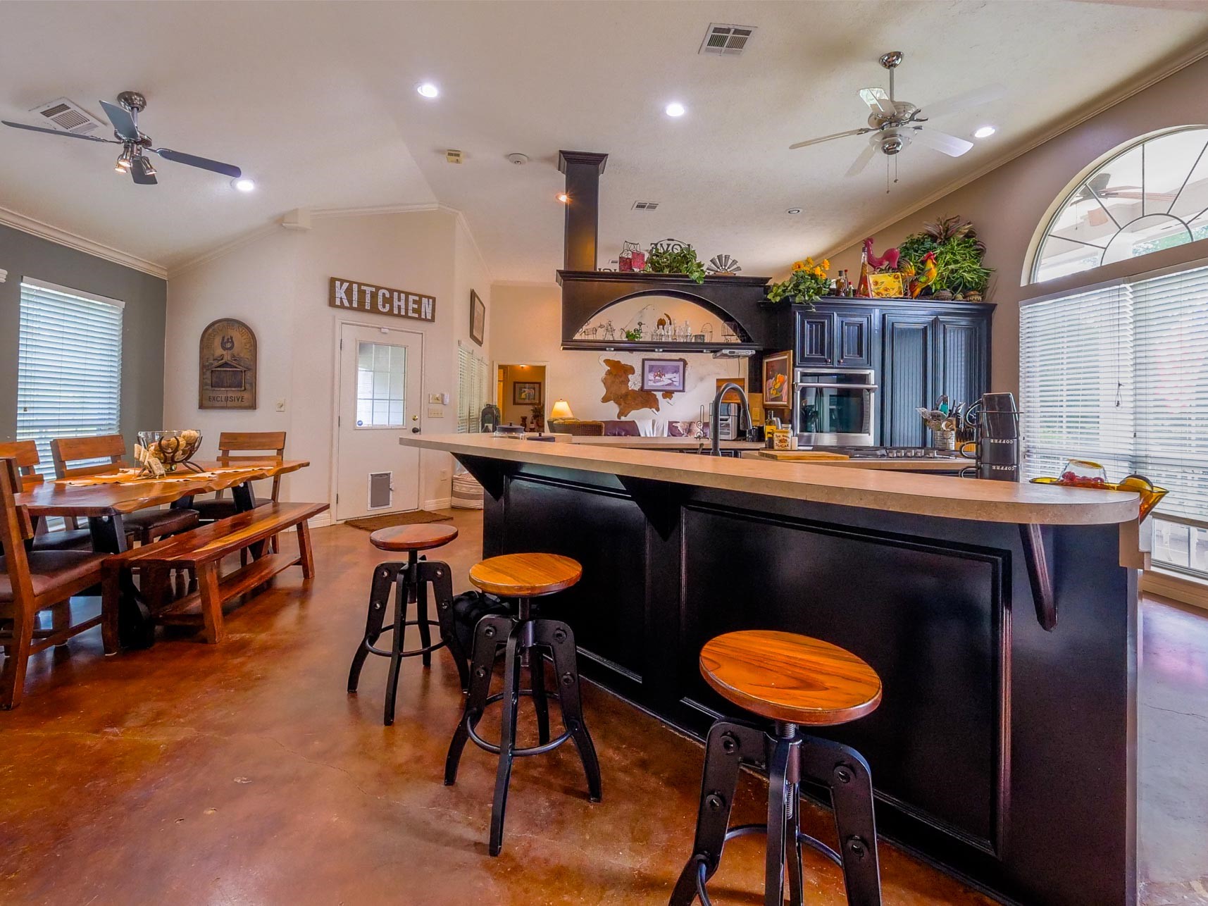 202 Jack White Road Livingston, TX 77351 - Photo 14 of 20 a kitchen with stainless steel appliances kitchen island granite countertop a table chairs sink and cabinets