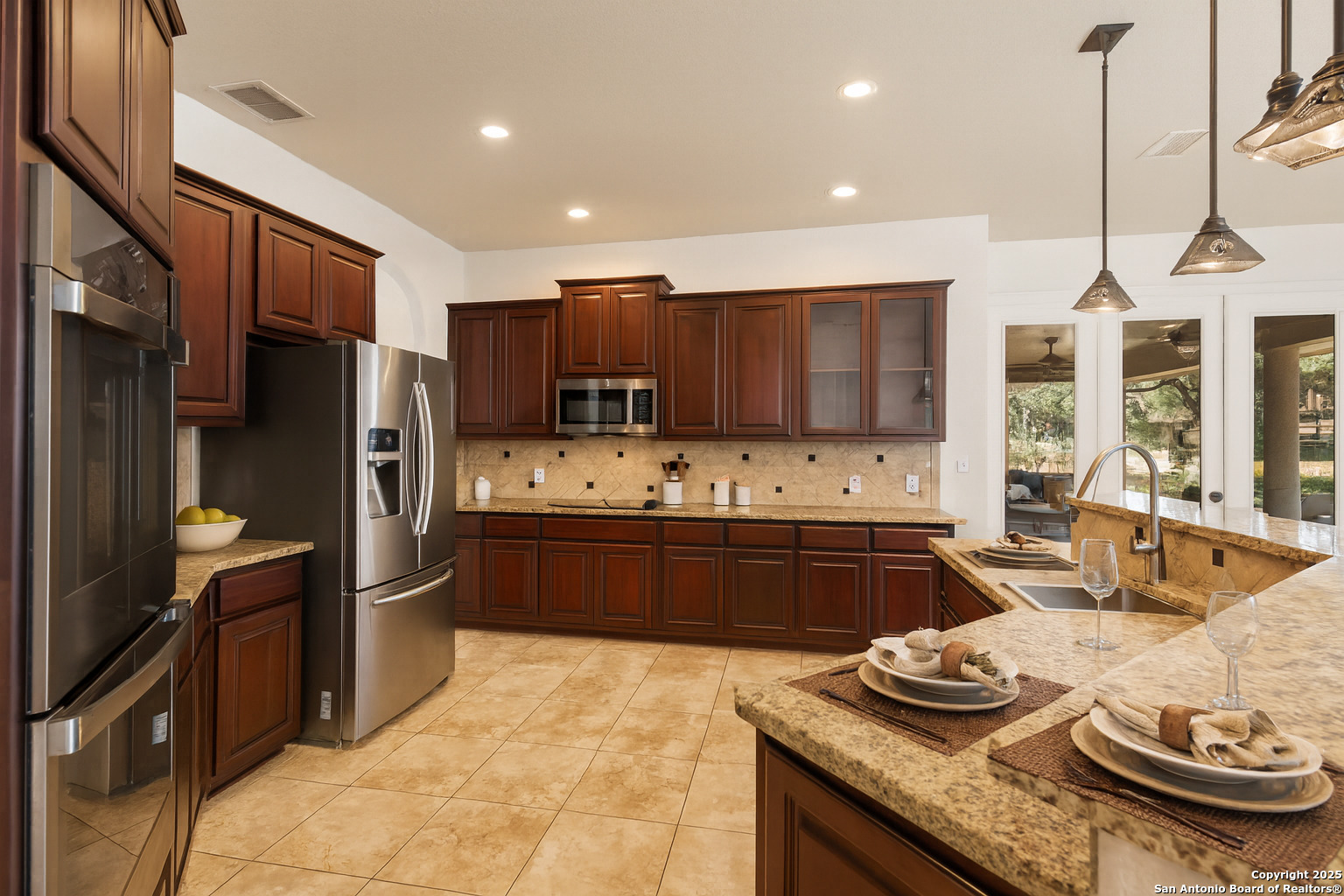 3015 River Way Spring Branch, TX 78070 - Photo 11 of 44 a kitchen with granite countertop stainless steel appliances and wooden cabinets