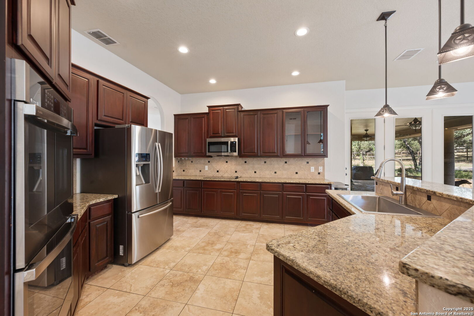 3015 River Way Spring Branch, TX 78070 - Photo 12 of 44 a large kitchen with granite countertop a large counter top appliances and cabinets