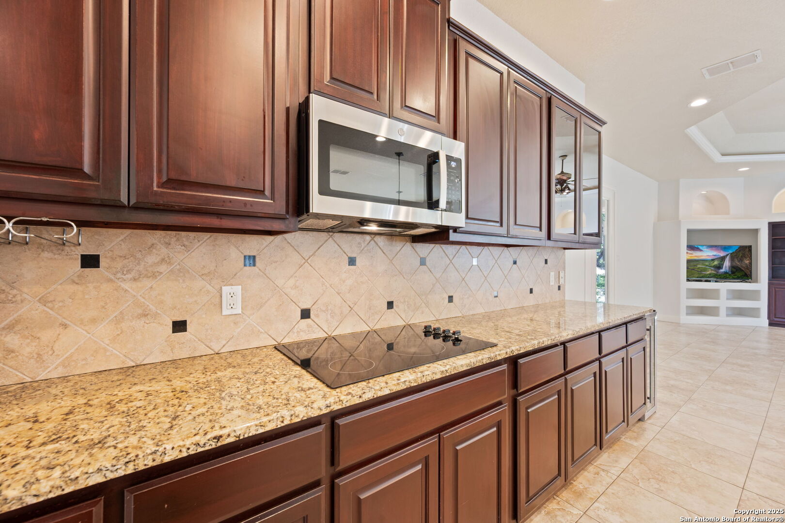 3015 River Way Spring Branch, TX 78070 - Photo 13 of 44 a kitchen with stainless steel appliances granite countertop a sink stove and microwave