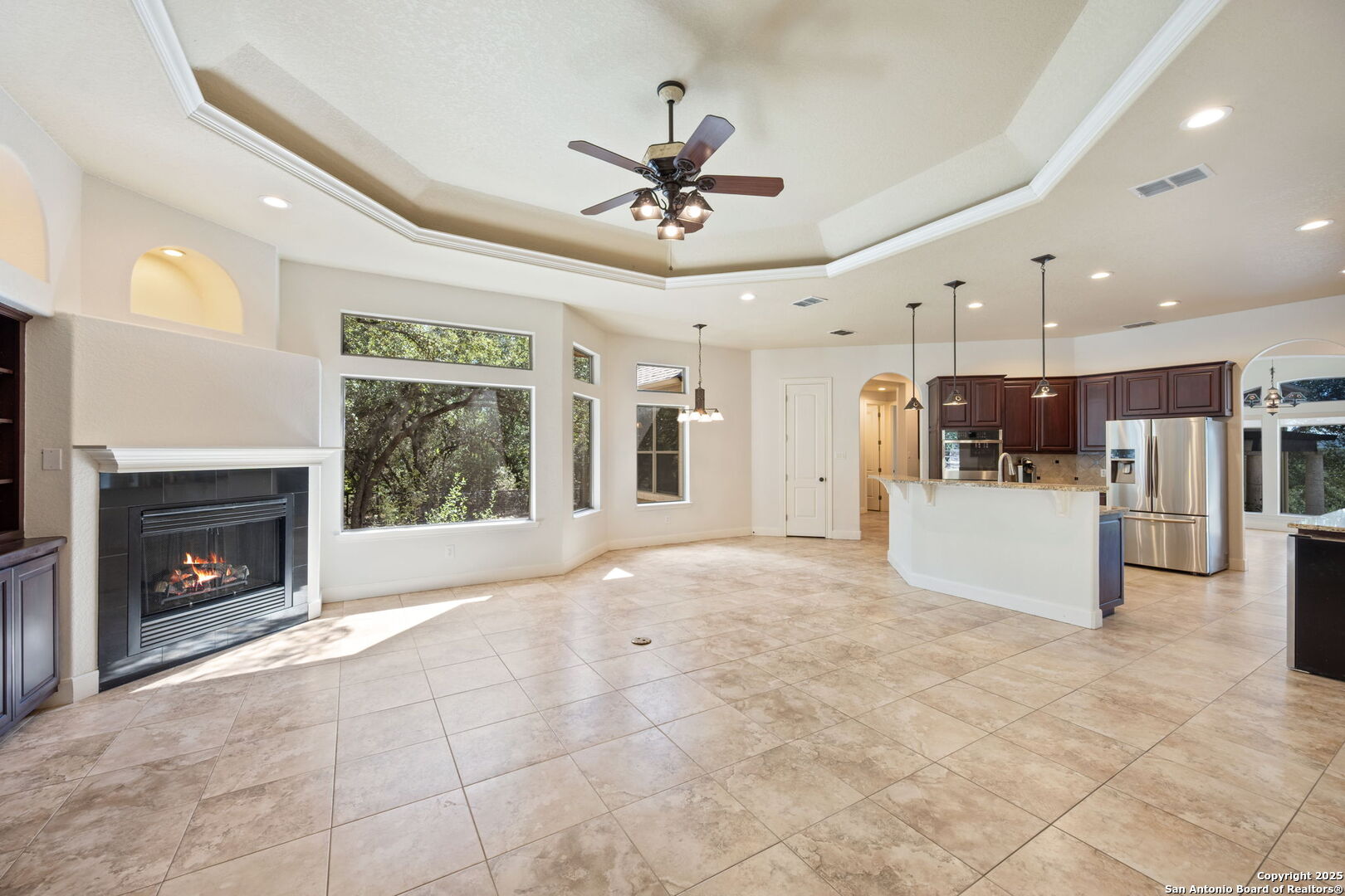 3015 River Way Spring Branch, TX 78070 - Photo 15 of 44 a view of an empty room with a fireplace and a ceiling fan