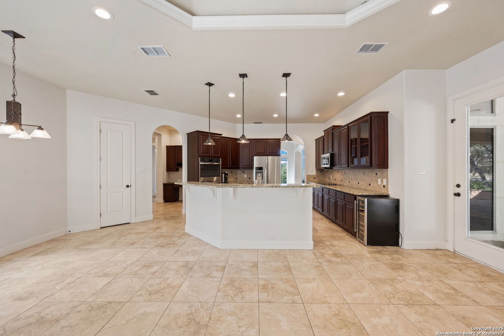 3015 River Way Spring Branch, TX 78070 - Photo 17 of 44 a large kitchen with stainless steel appliances kitchen island a large counter top and a view of living room