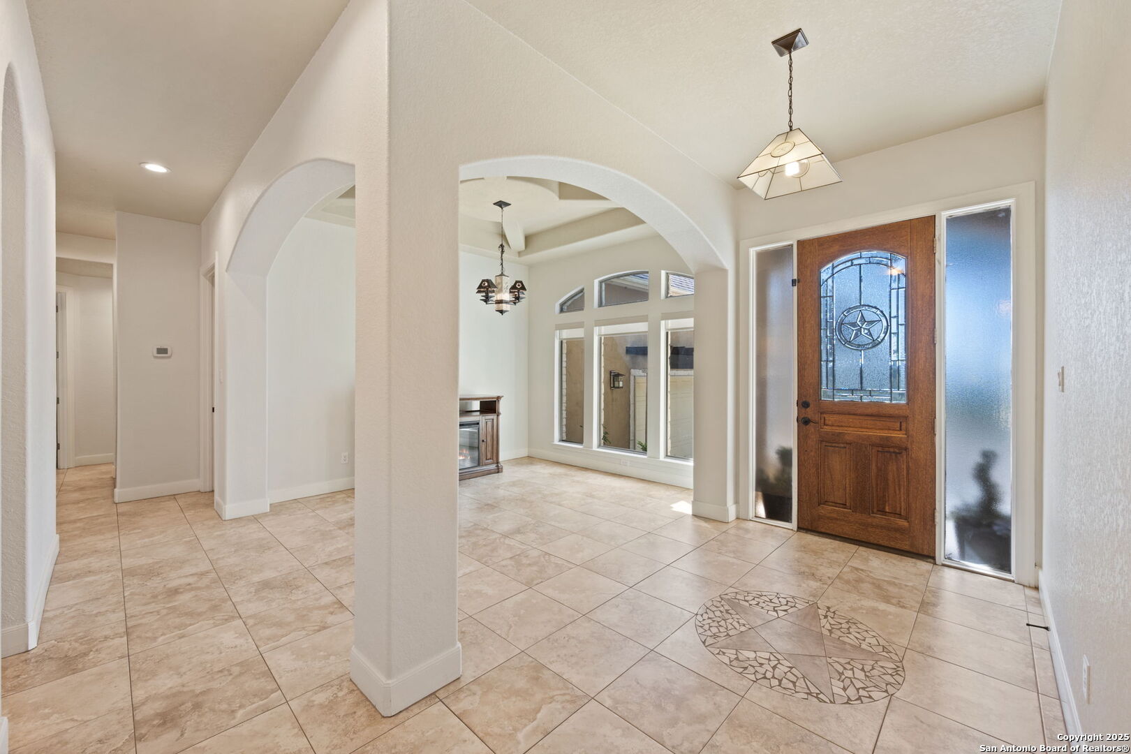3015 River Way Spring Branch, TX 78070 - Photo 5 of 44 a view of a hallway with wooden floor and a chandelier