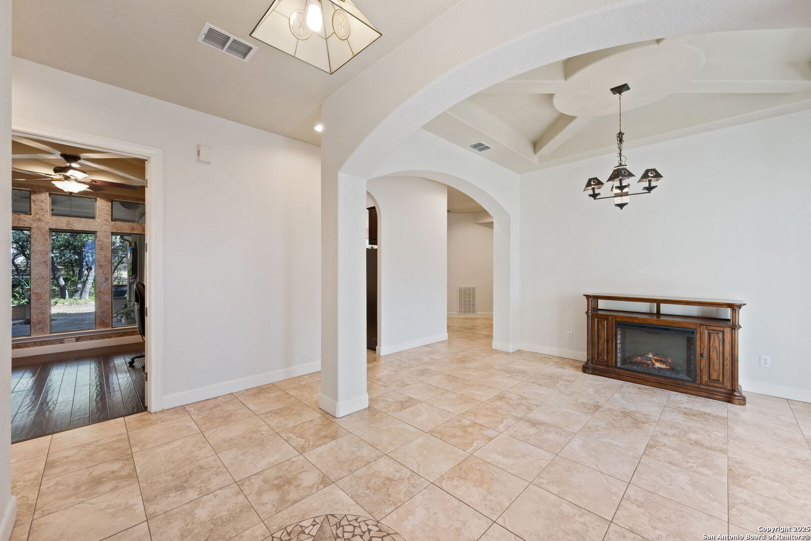 3015 River Way Spring Branch, TX 78070 - Photo 8 of 44 a view of a livingroom with a chandelier fan and fire place