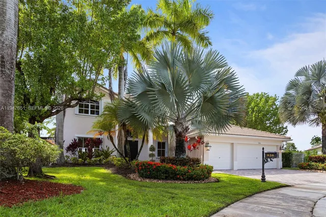 a view of a living room with a floor to ceiling window and wooden floor