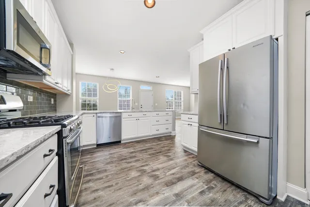 a kitchen with a refrigerator a sink and a stove