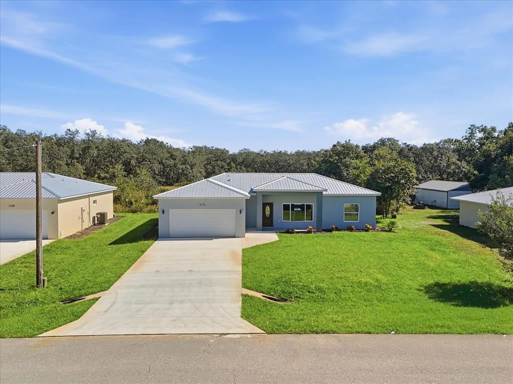 a view of house with a yard