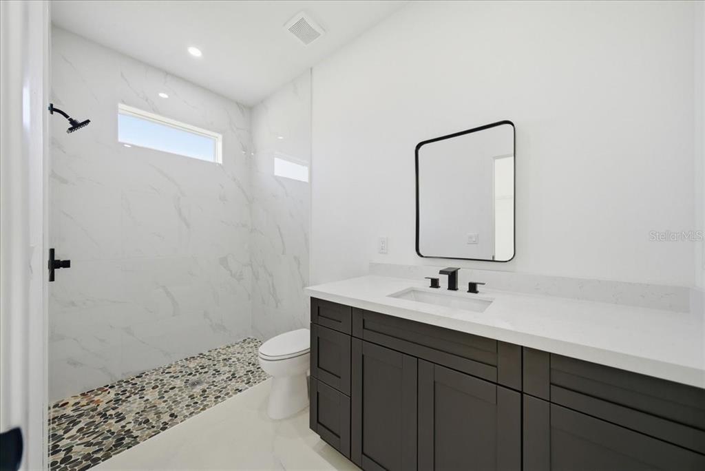 3174 North Sedgewick Road Avon Park, FL 33825 - Photo 4 of 12 a bathroom with a sink a toilet and shower