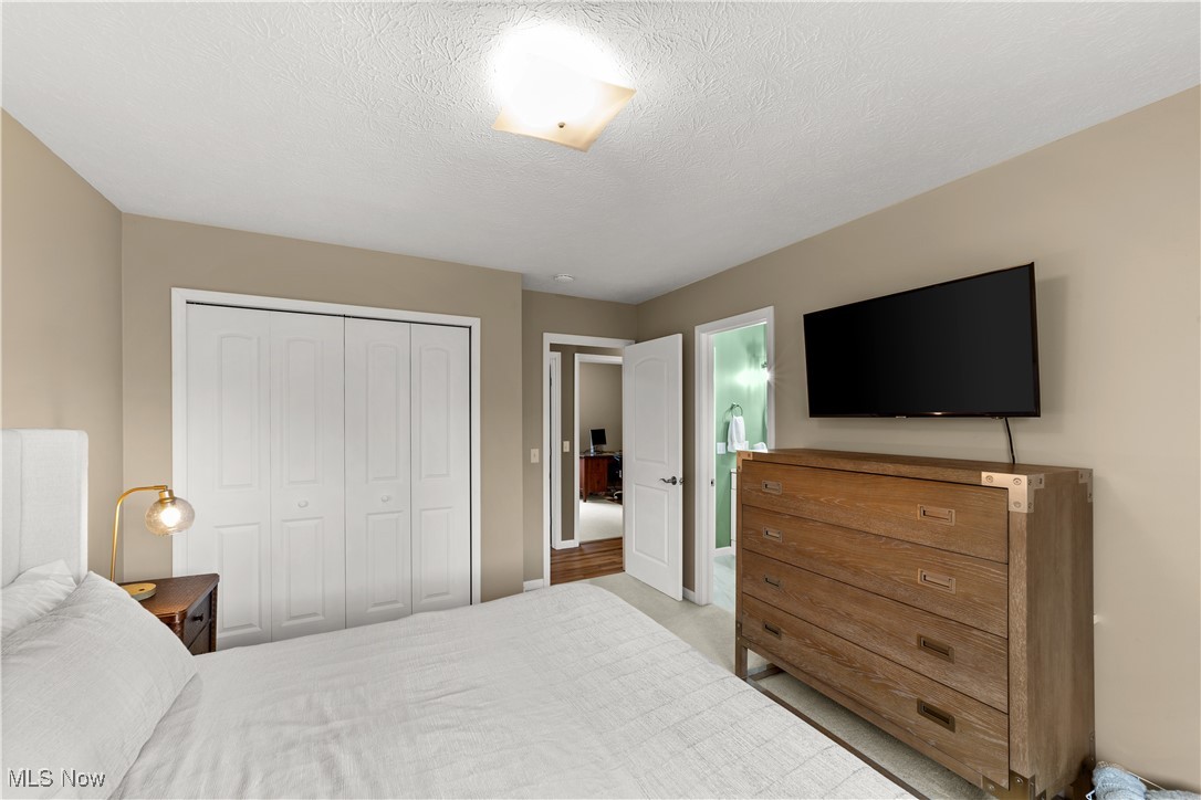 2977 Reeves Road Willoughby, OH 44094 - Photo 24 of 49 Carpeted bedroom with baseboards, a textured ceiling, and a closet