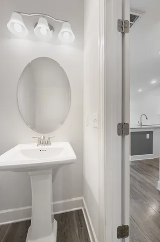 a bathroom with a granite countertop sink a mirror and a shower