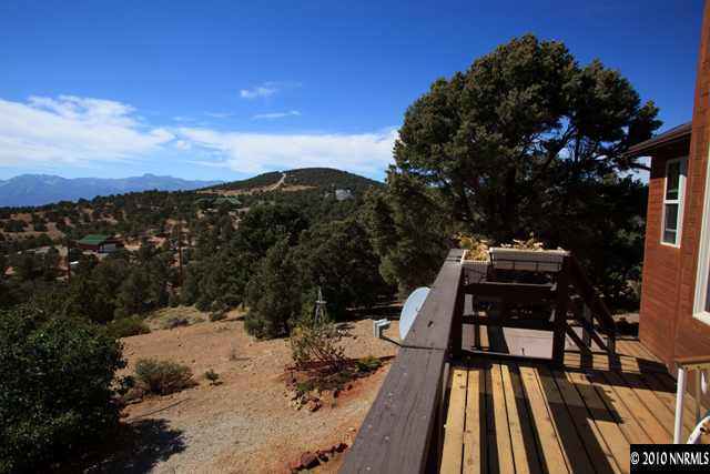 1991 Saddleback Road Reno, NV 89521 - Photo 4 of 13 a view of a roof deck with chair and wooden floor