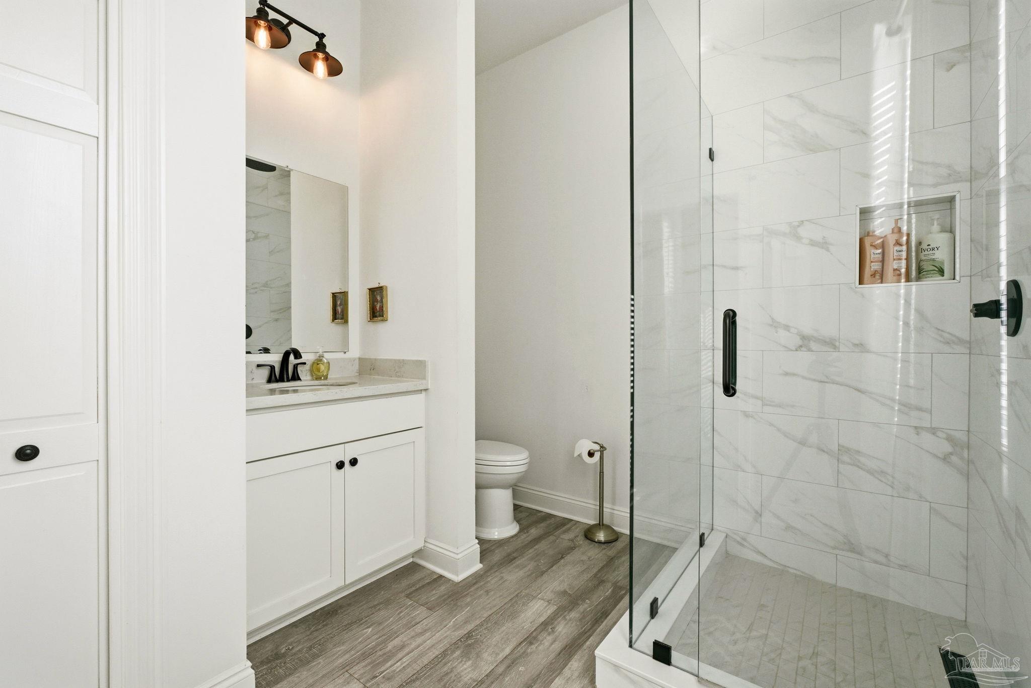 714 East La Rua Street Pensacola, FL 32501 - Photo 49 of 63 a bathroom with a granite countertop sink toilet a shower and a mirror