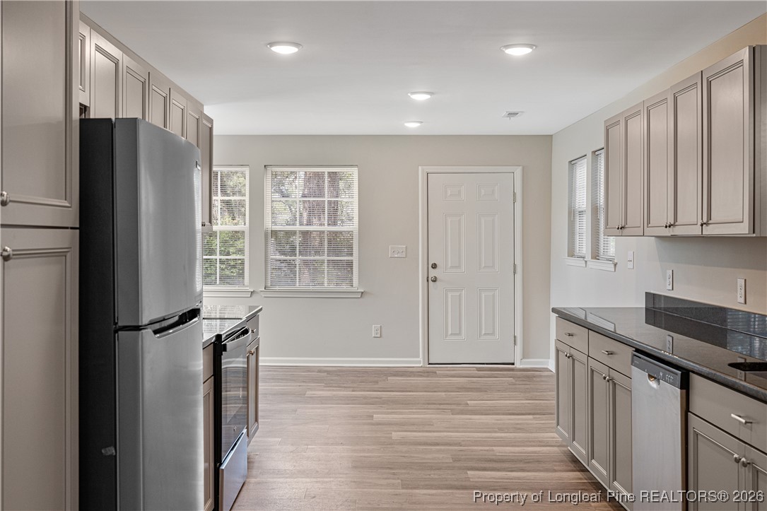 804 Porter Road Hope Mills, NC 28348 - Photo 14 of 42 a kitchen with stainless steel appliances granite countertop a refrigerator and a stove top oven
