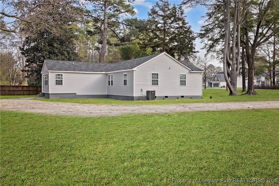 804 Porter Road Hope Mills, NC 28348 - Photo 39 of 42 a front view of house with yard and trees in the background