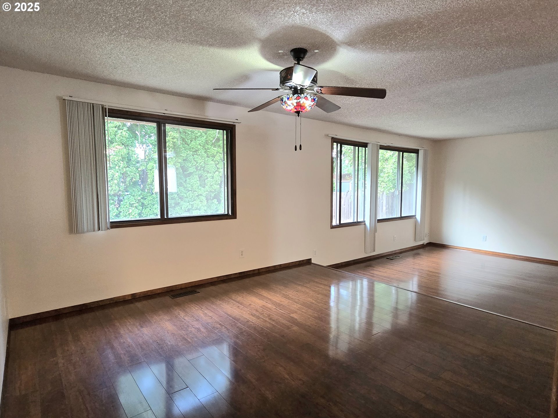 20675 Southwest Rosa Drive Beaverton, OR 97078 - Photo 11 of 40 a view of an empty room with wooden floor and a window
