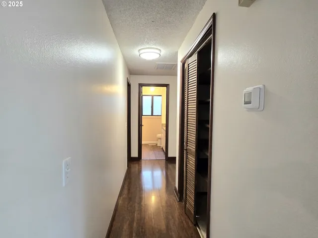 a view of hallway with wooden floor