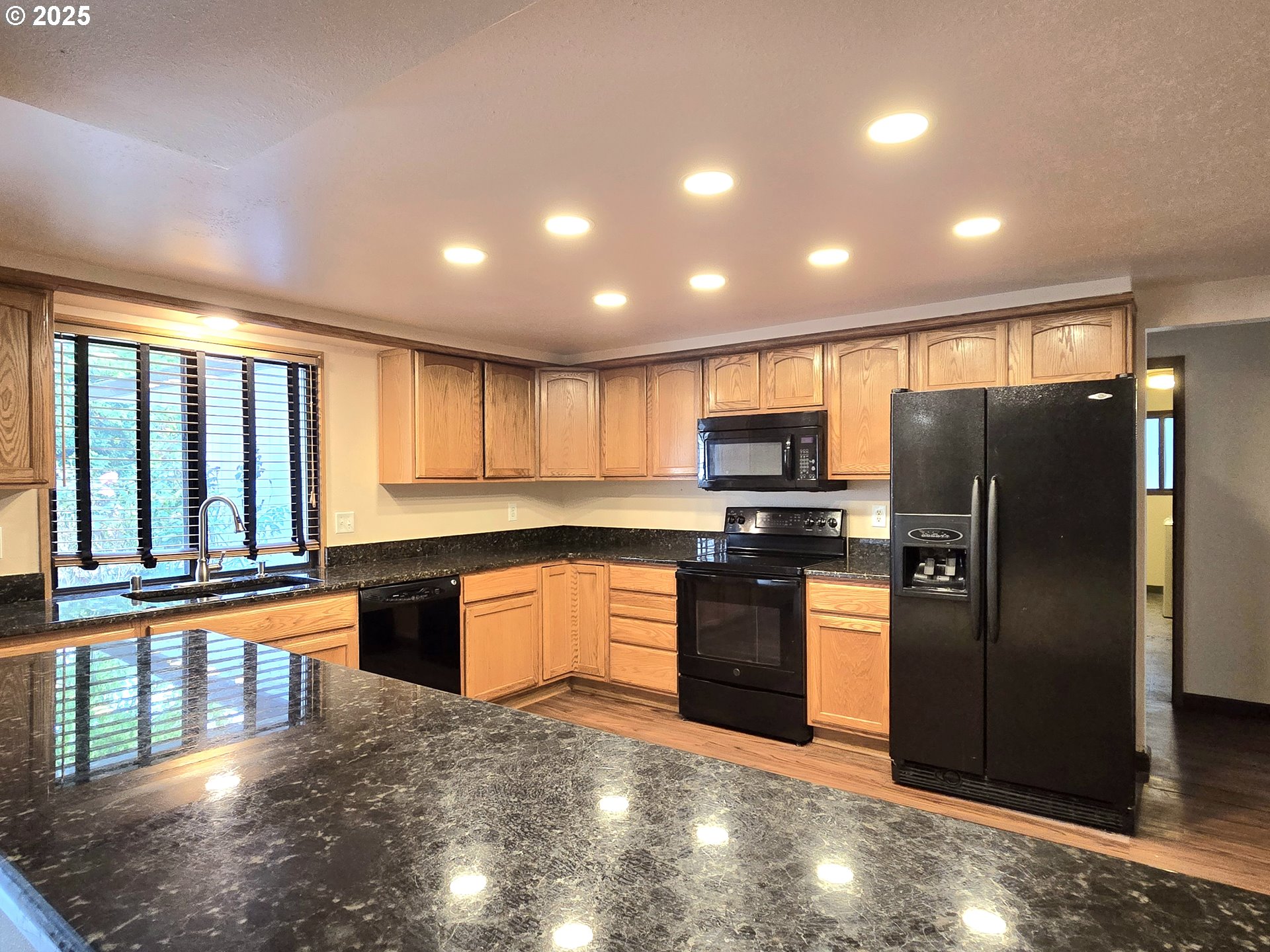 20675 Southwest Rosa Drive Beaverton, OR 97078 - Photo 6 of 40 a kitchen with stainless steel appliances granite countertop a refrigerator and a stove top oven