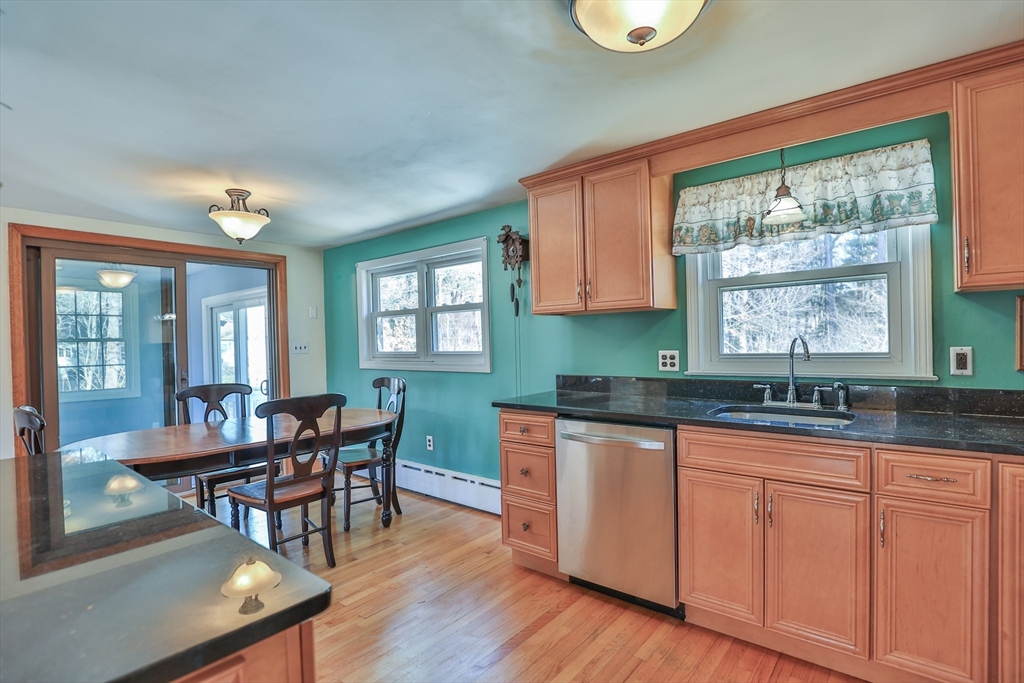 14 Jef Road Billerica, MA 01821 - Photo 12 of 42 a kitchen with granite countertop a dining table chairs and a large window