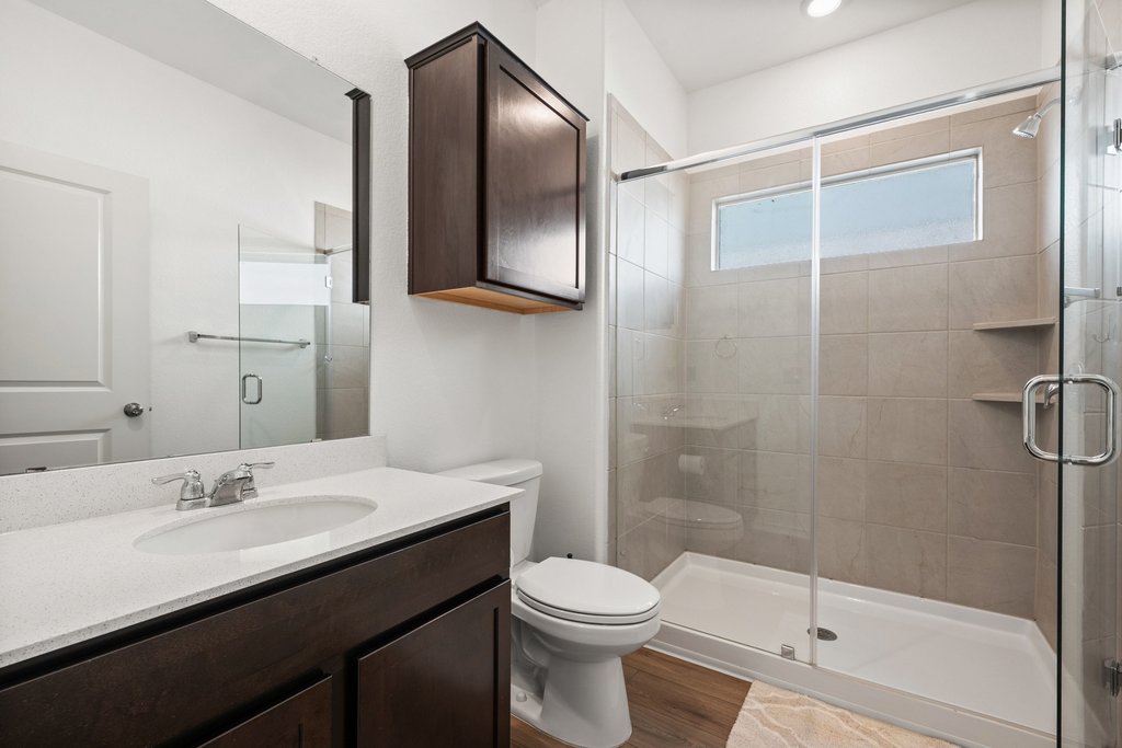 1233 Sweetspire Street Leander, TX 78641 - Photo 28 of 40 Full guest suite bath with walk-in shower and modern finishes.