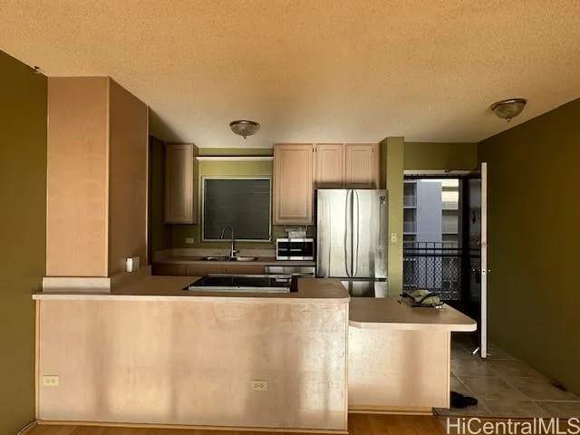 a kitchen with stainless steel appliances a refrigerator and a stove