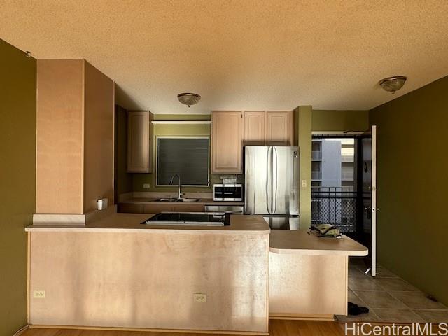 98-707 Iho Place, Unit 1004 Aiea, HI 96701 - Photo 1 of 20 a kitchen with stainless steel appliances a refrigerator and a stove