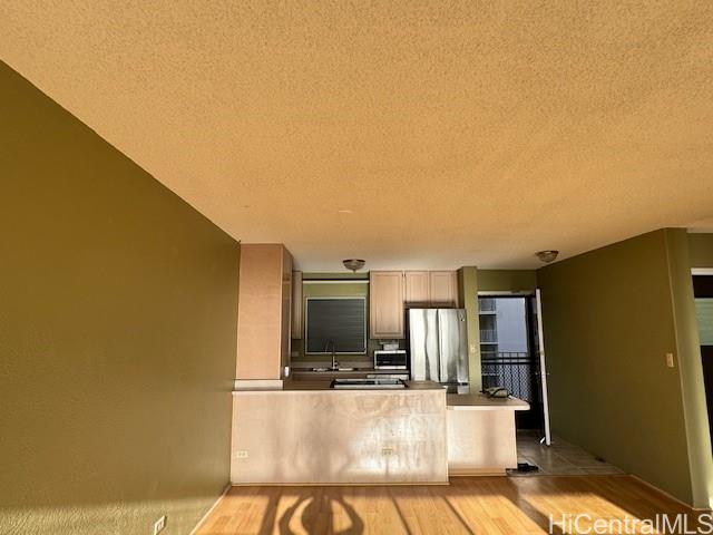 98-707 Iho Place, Unit 1004 Aiea, HI 96701 - Photo 4 of 20 a living room with a table chairs and a refrigerator