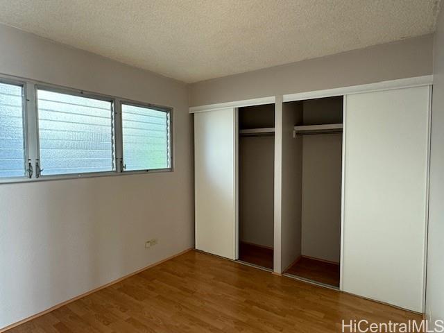 98-707 Iho Place, Unit 1004 Aiea, HI 96701 - Photo 6 of 20 an empty room with windows