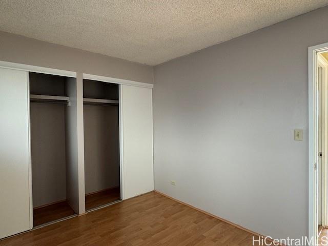 98-707 Iho Place, Unit 1004 Aiea, HI 96701 - Photo 8 of 20 an empty room with wooden floor