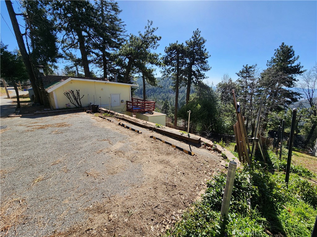 21657 Vista Road Cedarpines Park, CA 92322 - Photo 26 of 39 a view of a house with a yard and covered tree