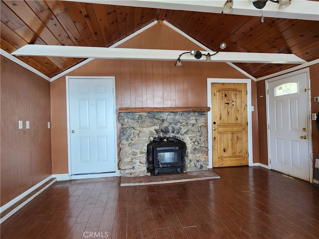 21657 Vista Road Cedarpines Park, CA 92322 - Photo 8 of 39 a room with fireplace and wooden floor