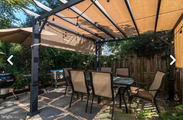 a view of patio with table and chairs and potted plants