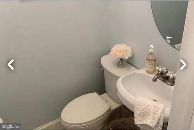a bathroom with a toilet sink and mirror