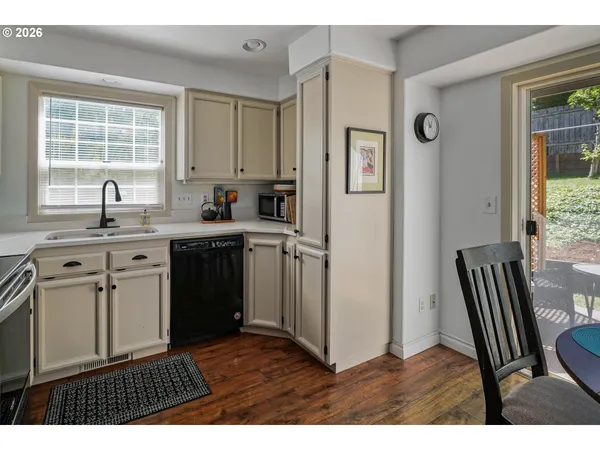 a kitchen with cabinets stainless steel appliances and a window