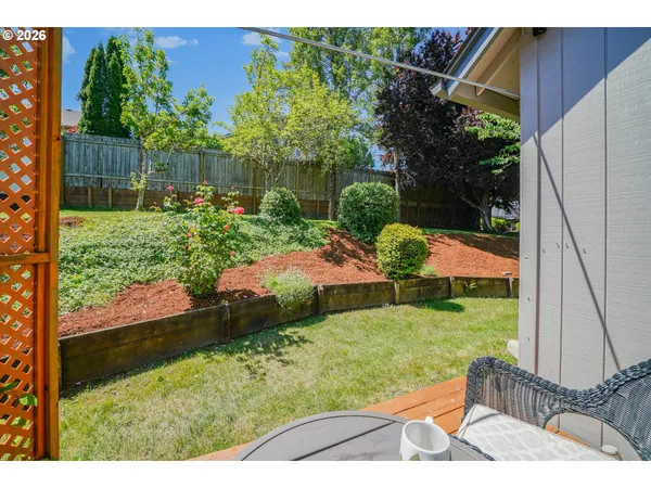 a view of backyard with seating area and green space