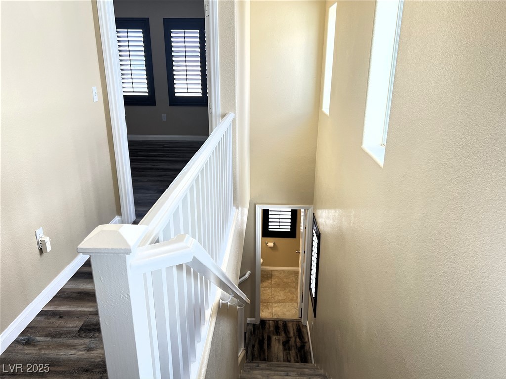 9535 Leaping Lizard Street Las Vegas, NV 89178 - Photo 21 of 37 Hallway on third floor leading to primary bedroom and looking down to second floor half bath.