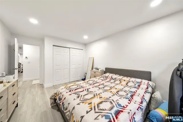 a bedroom with a large bed and a wooden floor