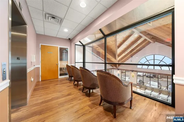 a living room with wooden floor and furniture