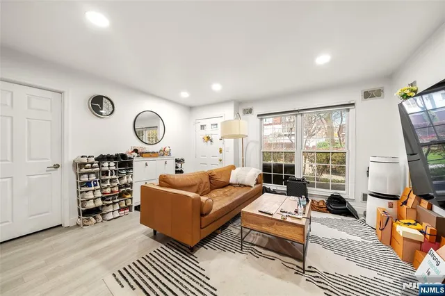 a living room with furniture a rug and a large window