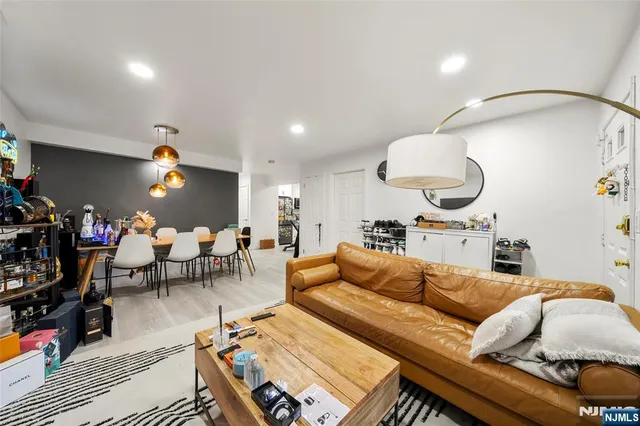 a living room with lots of furniture and a chandelier