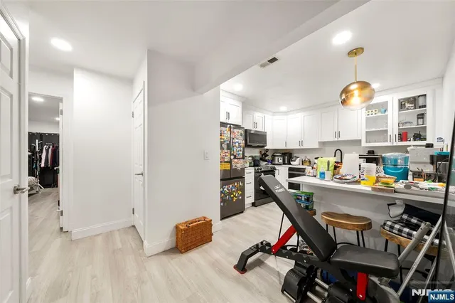 a kitchen view with stainless steel appliances a stove and cabinets