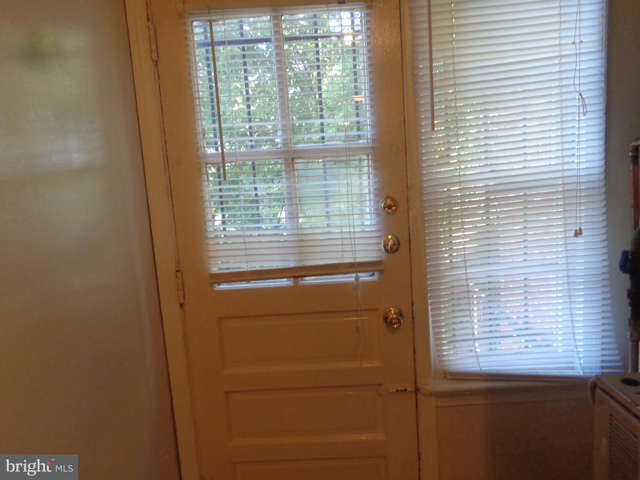 5024 Astor Place Southeast Washington, DC 20019 - Photo 19 of 19 Vcant unit rear exit doorway and window from kitch